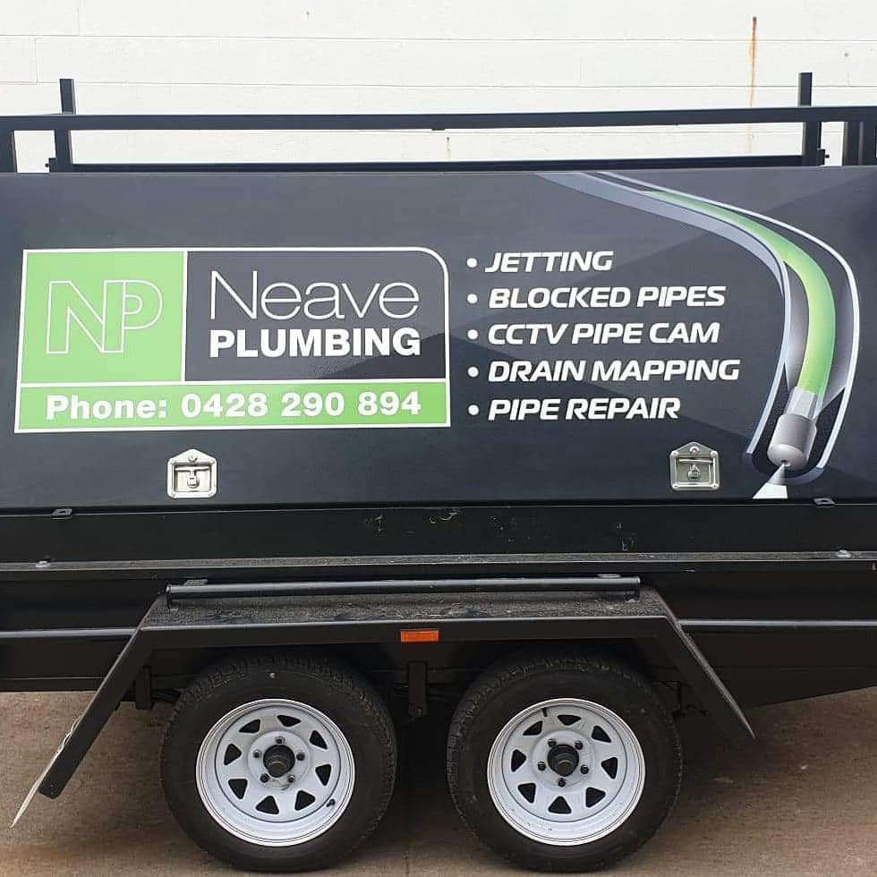 Neave Plumbing trailer with logo graphic